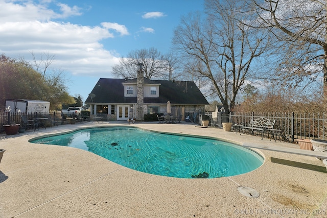 view of pool featuring french doors and a patio area