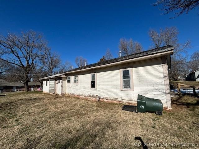 view of property exterior with a yard