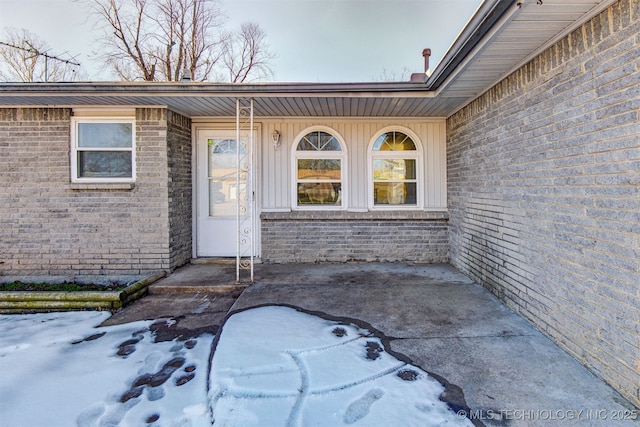 view of snow covered property entrance