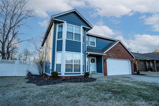 view of front facade featuring a front yard and a garage