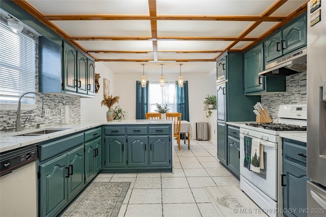 kitchen featuring tasteful backsplash, kitchen peninsula, sink, and white appliances