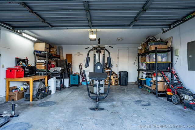 garage with electric panel and a garage door opener