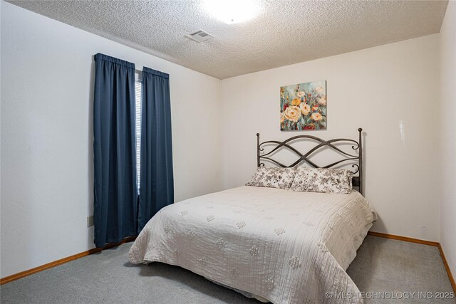 carpeted bedroom with a textured ceiling