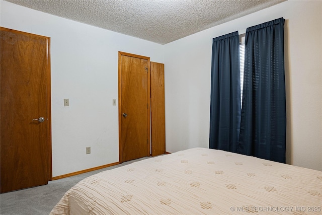 carpeted bedroom featuring a textured ceiling