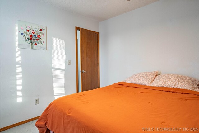 bedroom featuring carpet floors and a textured ceiling