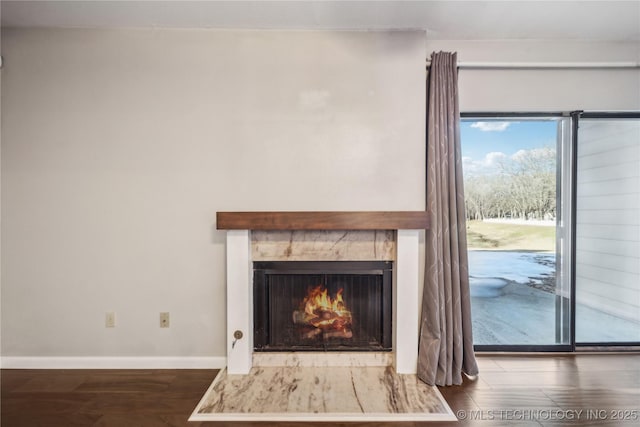 interior details featuring a high end fireplace and hardwood / wood-style flooring