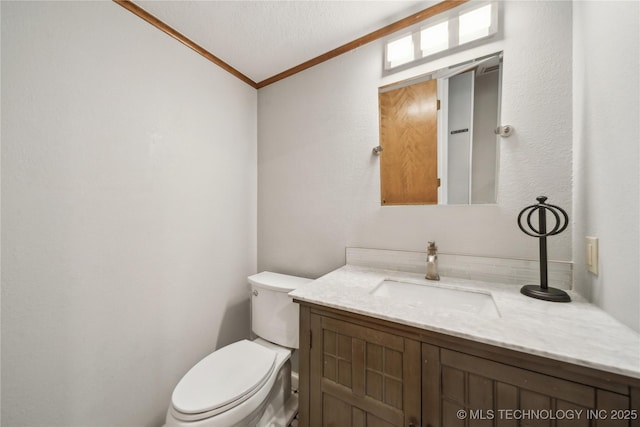 bathroom featuring toilet, ornamental molding, lofted ceiling, and vanity