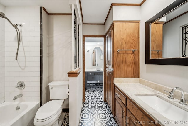 full bathroom with toilet, vanity, ornamental molding, and tiled shower / bath