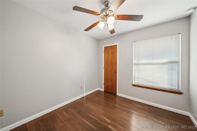 spare room with ceiling fan and dark wood-type flooring