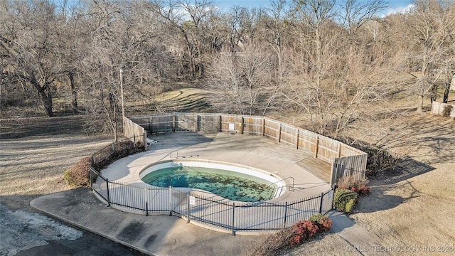 view of swimming pool featuring a hot tub