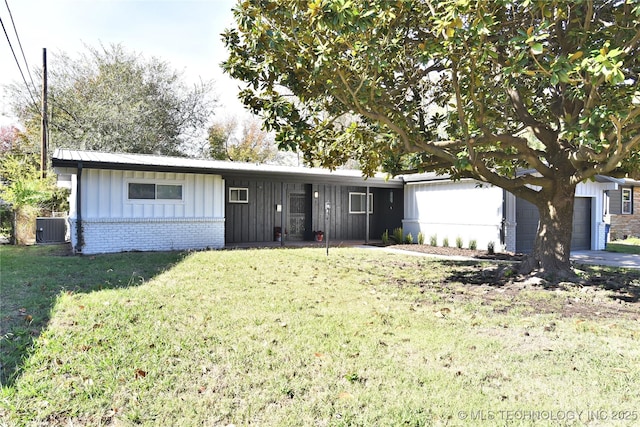 single story home with a garage, a front lawn, and central air condition unit