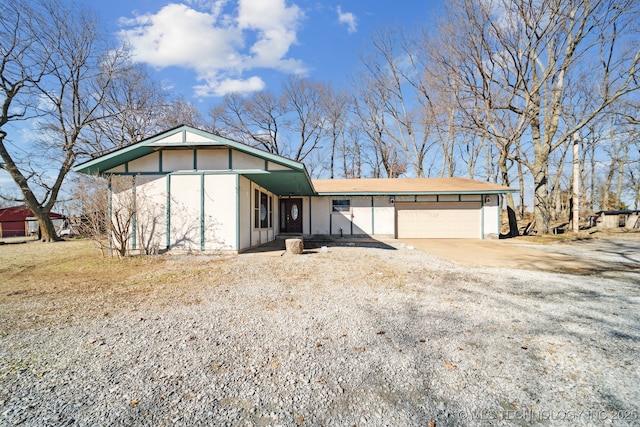 view of front of property with concrete driveway and a garage