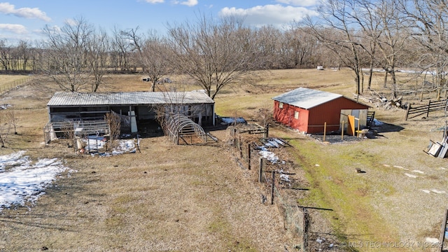 view of yard with a rural view, an exterior structure, an outdoor structure, and a pole building