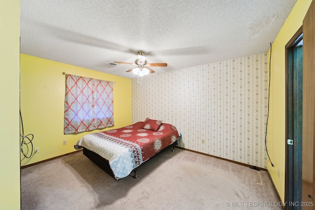 carpeted bedroom with baseboards, a textured ceiling, ceiling fan, and wallpapered walls