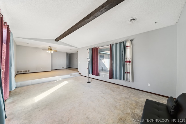 unfurnished living room with lofted ceiling with beams, visible vents, carpet, and a textured ceiling