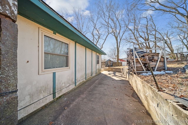 view of side of home with stucco siding