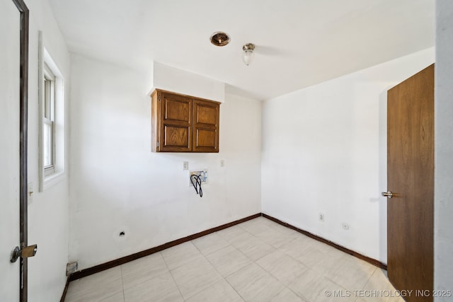 spare room with baseboards