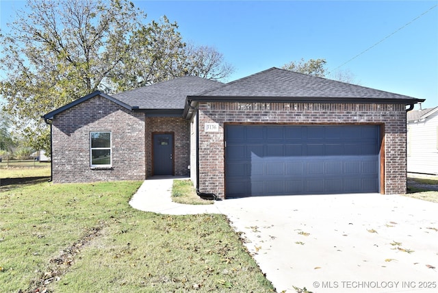 view of front of property featuring a garage and a front lawn