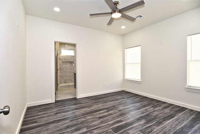 spare room featuring ceiling fan and dark hardwood / wood-style flooring