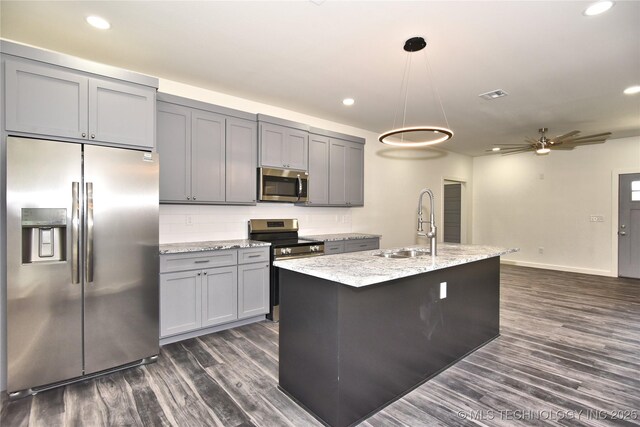 kitchen featuring ceiling fan, pendant lighting, appliances with stainless steel finishes, and gray cabinetry