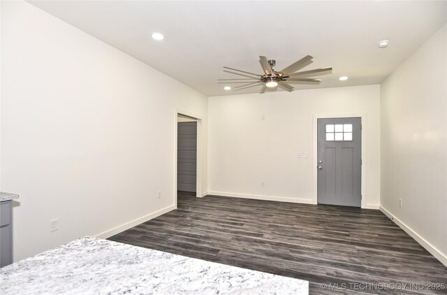 foyer with ceiling fan and dark hardwood / wood-style floors