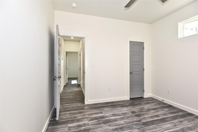 unfurnished bedroom featuring dark wood-type flooring and ceiling fan