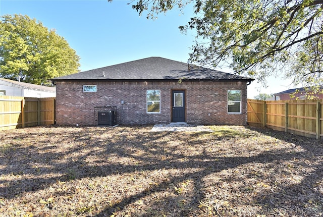 rear view of house with central AC unit