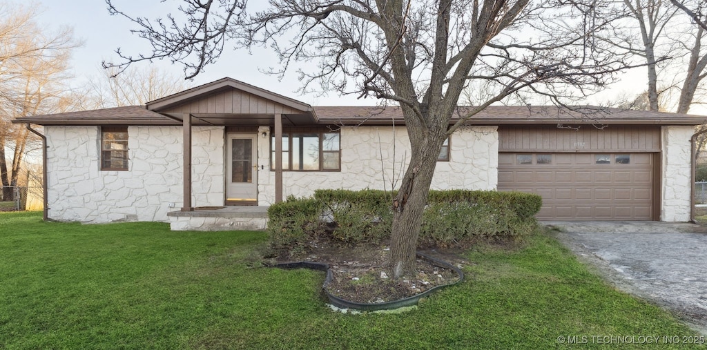 ranch-style house with a front yard and a garage