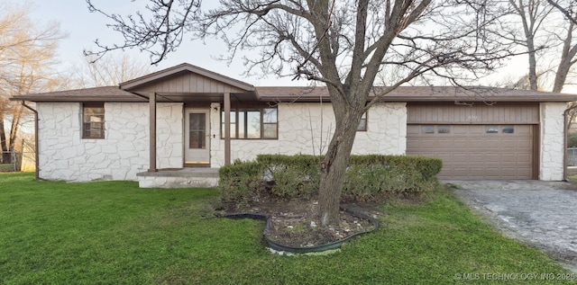 ranch-style house with a front yard and a garage