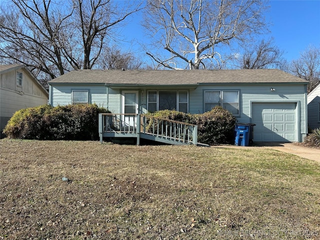 ranch-style home with a garage and a front yard