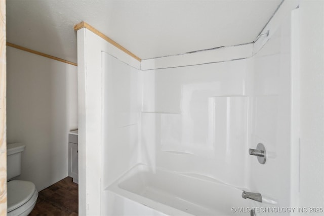 bathroom featuring walk in shower, toilet, and hardwood / wood-style flooring