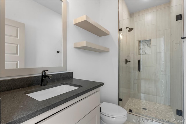 full bathroom with toilet, a shower stall, and vanity