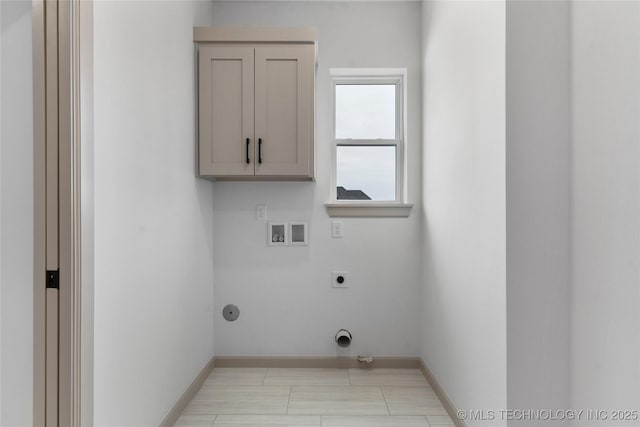 laundry room with cabinet space, hookup for a washing machine, baseboards, and electric dryer hookup