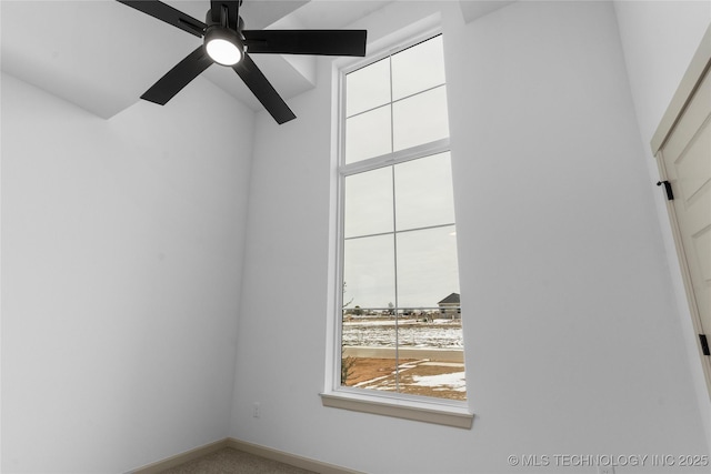 unfurnished room featuring ceiling fan and baseboards