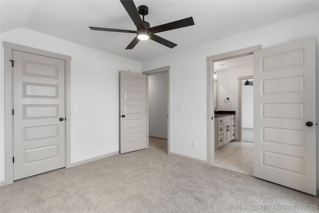 unfurnished bedroom featuring light carpet, ceiling fan, and baseboards