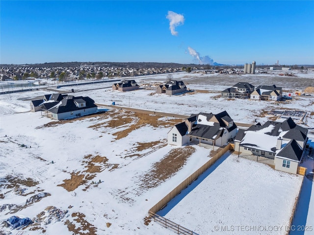 snowy aerial view featuring a residential view