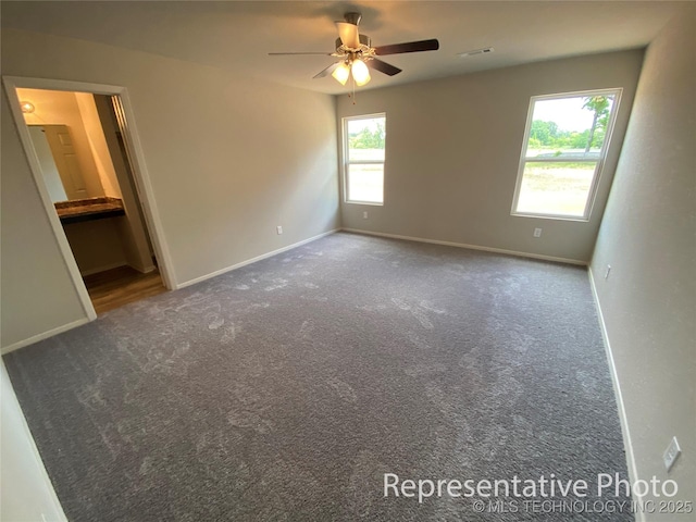 carpeted empty room with ceiling fan