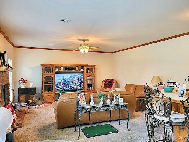 living room with ceiling fan, carpet, ornamental molding, and a fireplace