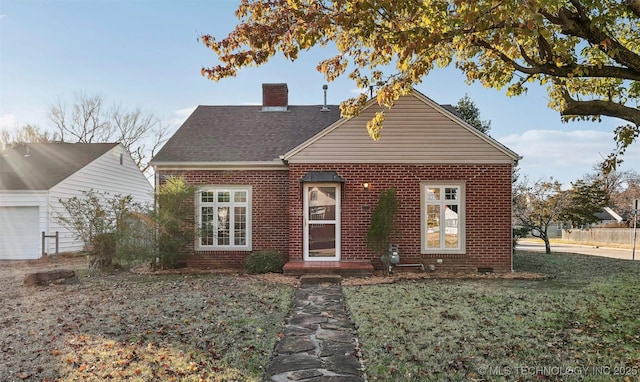 view of front of house featuring a garage and a front lawn