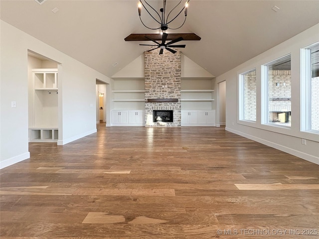 unfurnished living room featuring ceiling fan with notable chandelier, a fireplace, hardwood / wood-style floors, and built in features