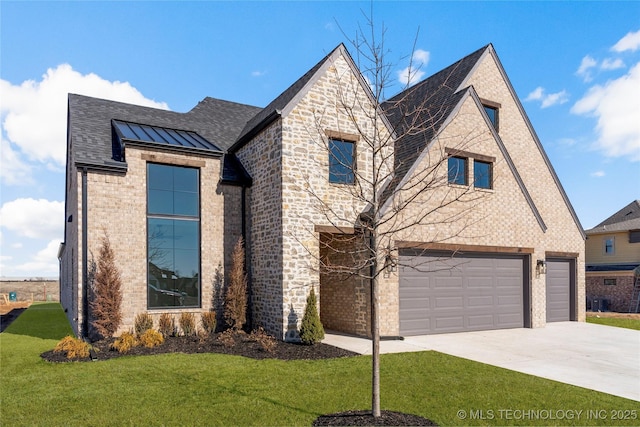 view of front of property featuring a garage and a front lawn