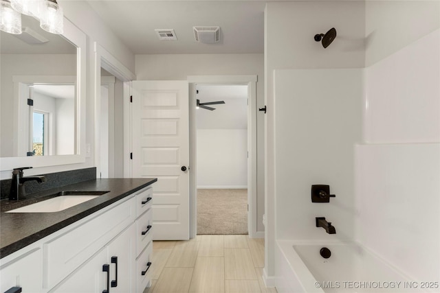 bathroom featuring vanity and shower / tub combination