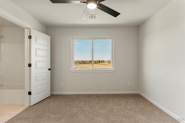 spare room with light carpet and ceiling fan