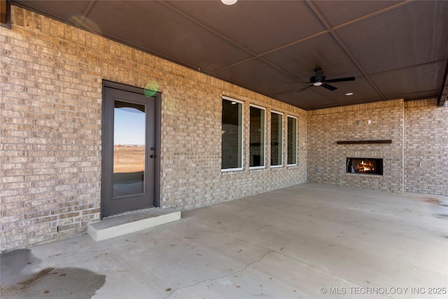 view of patio featuring ceiling fan and exterior fireplace