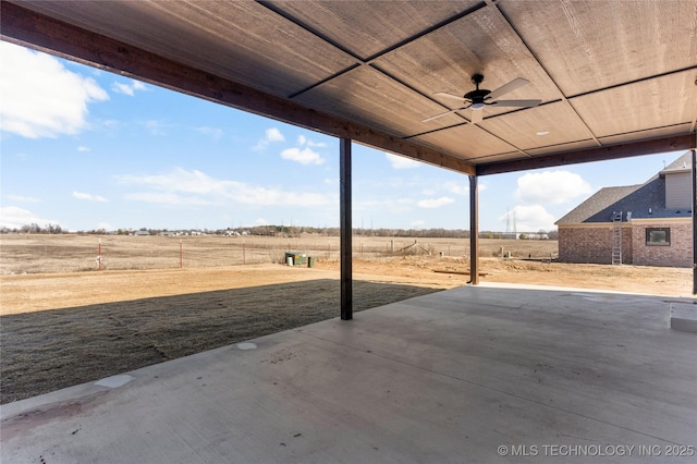 view of patio with a rural view and ceiling fan