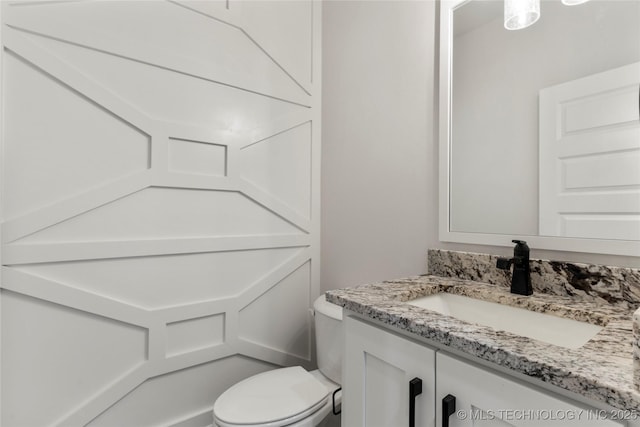 bathroom with vanity and toilet