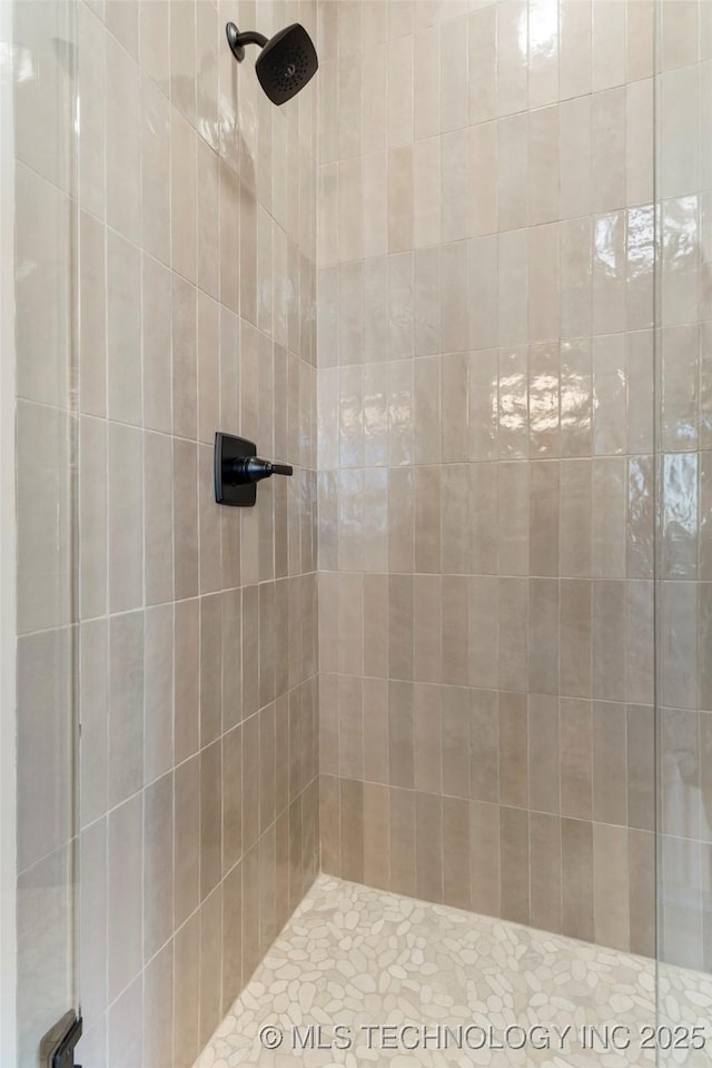 bathroom with a tile shower