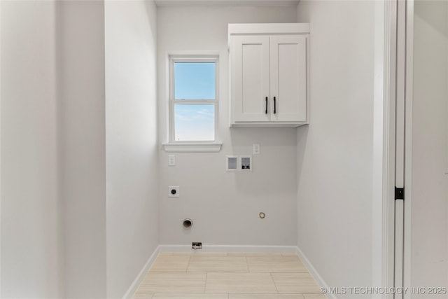 laundry room featuring washer hookup, gas dryer hookup, cabinets, and hookup for an electric dryer