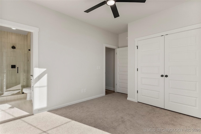 unfurnished bedroom with ceiling fan, ensuite bath, a closet, and light carpet