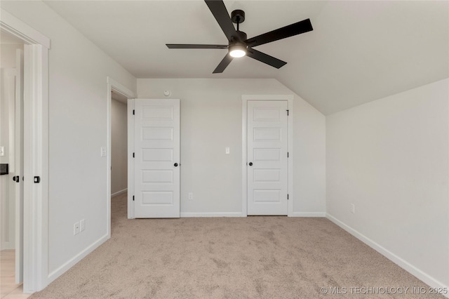 additional living space featuring ceiling fan, light colored carpet, and lofted ceiling